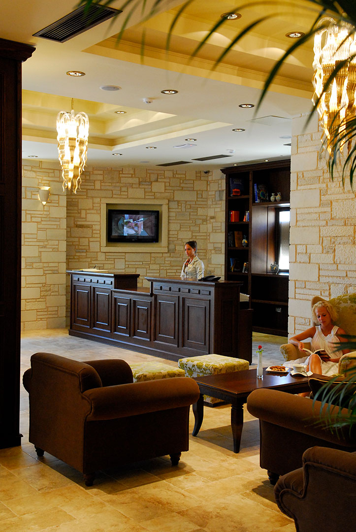 Hotel reception with wooden stand and stone wall