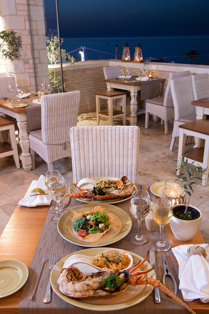 Restaurant table with served meals and night sky view