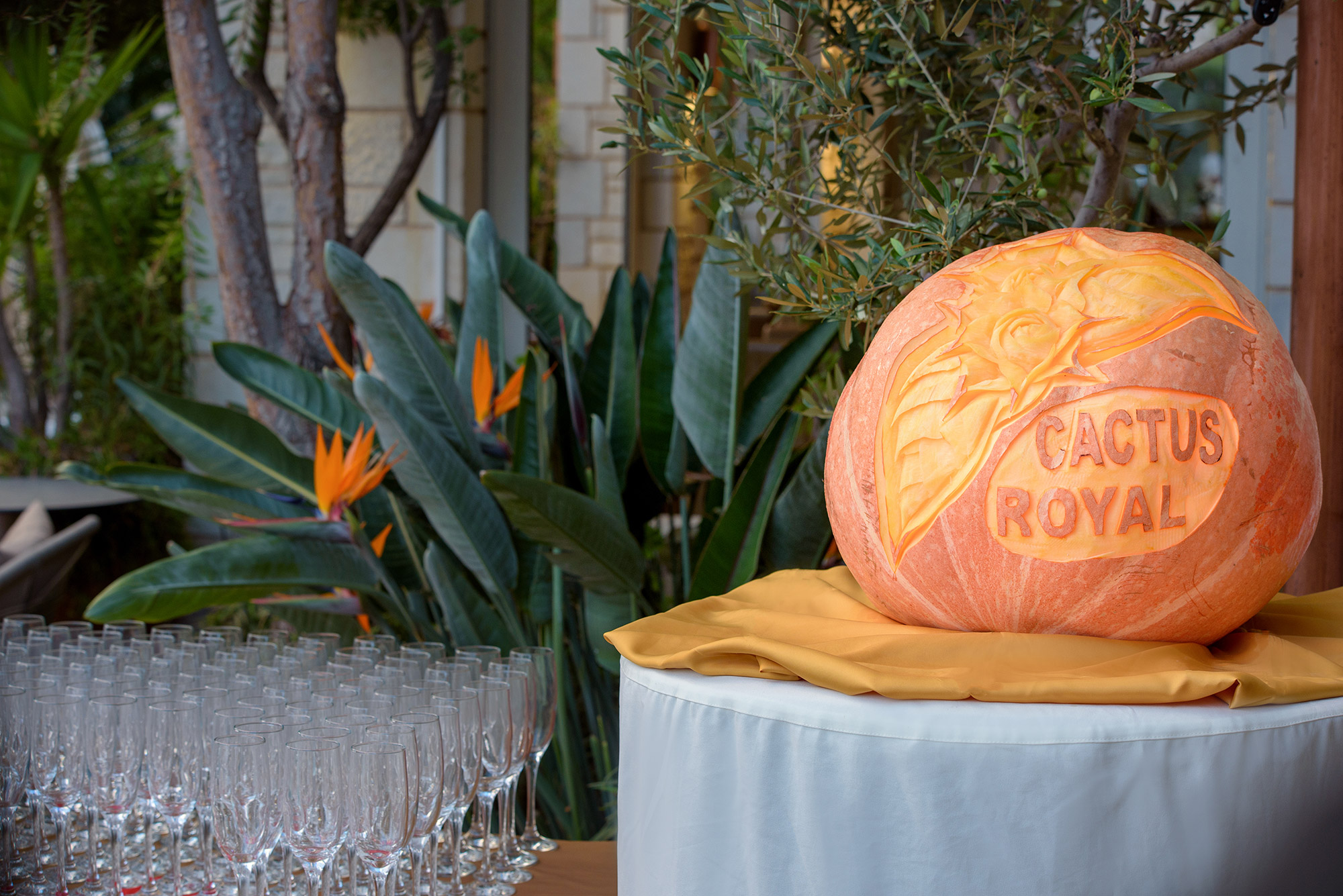 Decorated image with hotel logo and two glasses containing alcohol